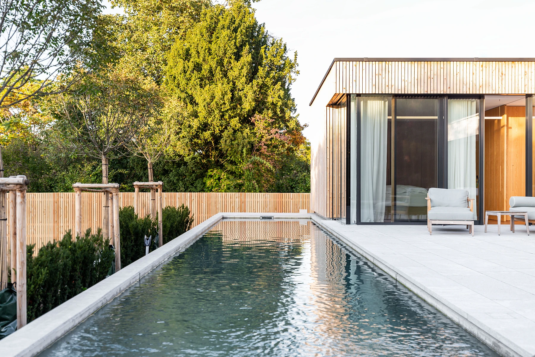 Außenansicht mit Pool eines Holzbau Einfamilienhauses