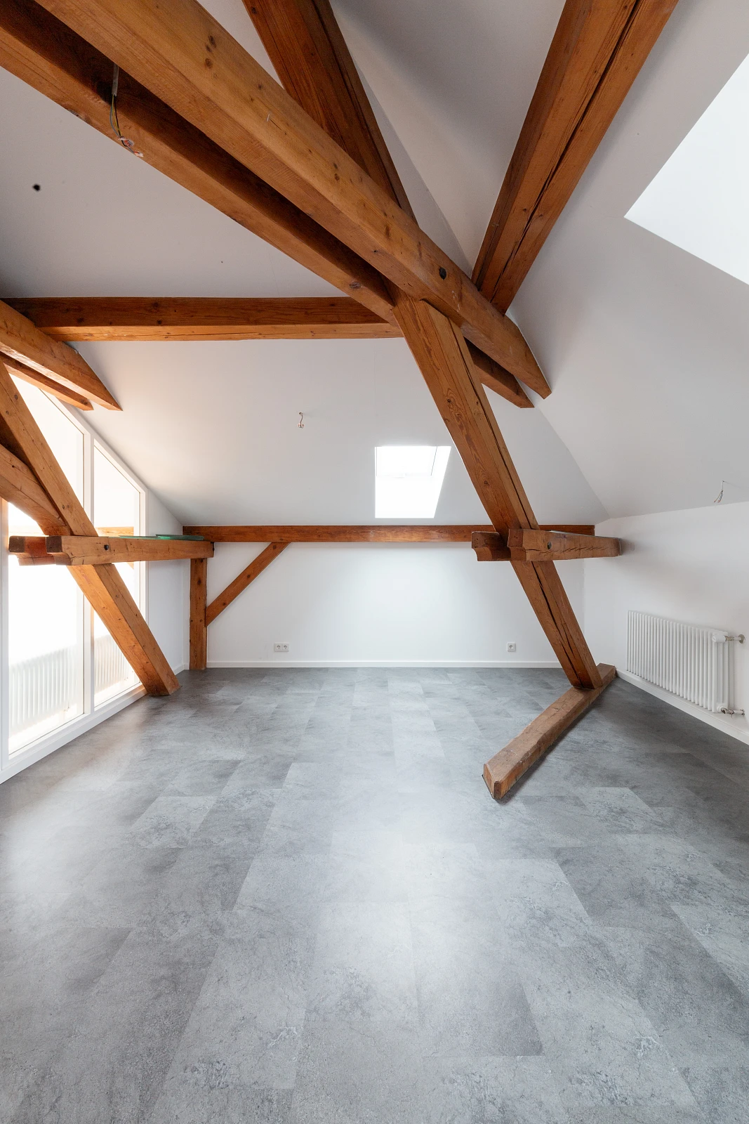 Heller Dachraum mit sichtbaren Gebälk und natürlichen Oberflächen