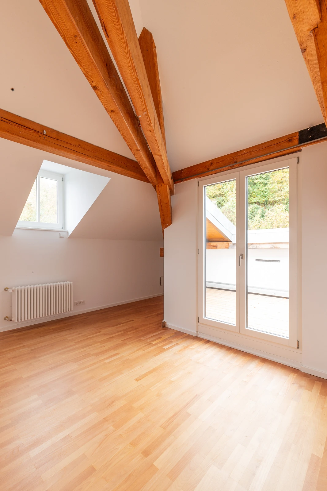 Heller Dachraum mit sichtbaren Gebälk und natürlichen Oberflächen
