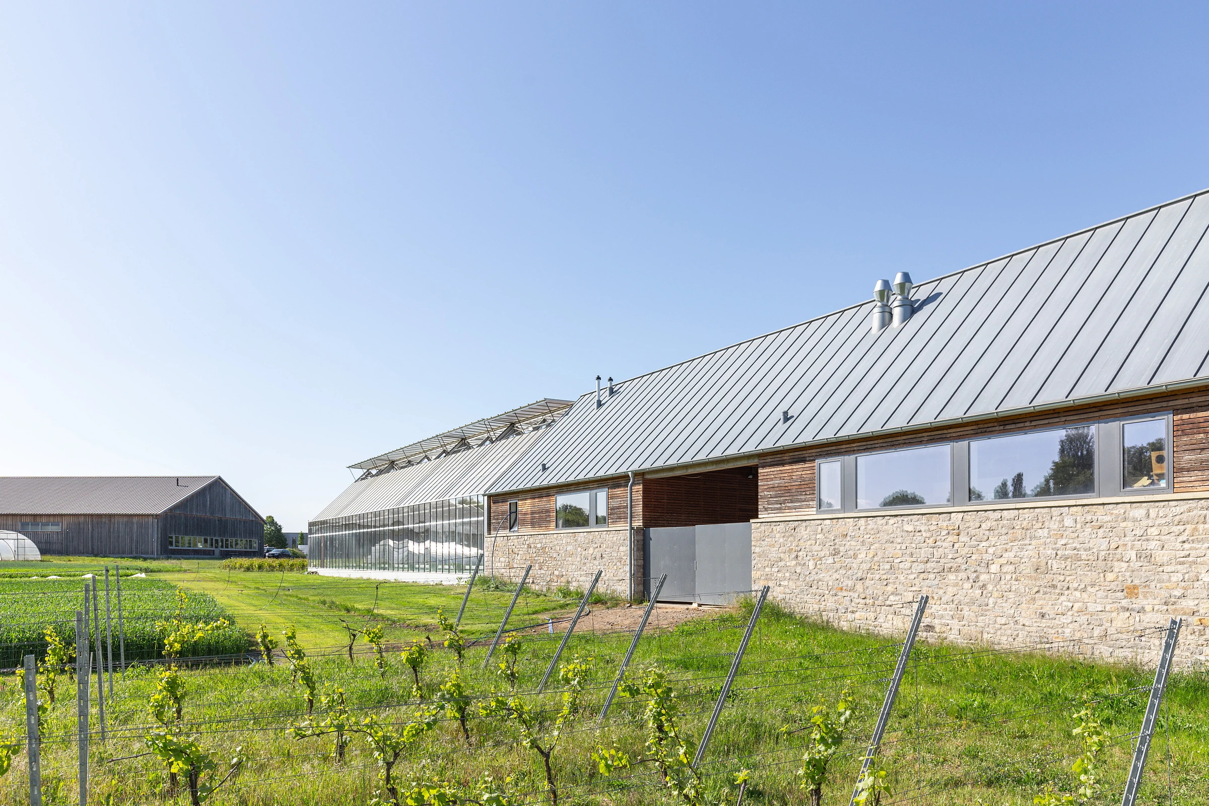 Außenansicht eines landwirtschaftlichen Gewächshauses als Anbau eines bestehenden Hofes